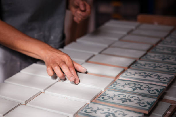 Artist hands choosing ceramic tiles in her studio