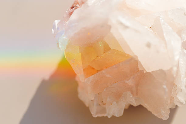 istock Luminous Quartz with Rainbow Flares. Sun's rays interact with quartz stone, iridescent rainbow glares, background with shining crystal at sunlight, aesthetic view with natural light effect 2164818674