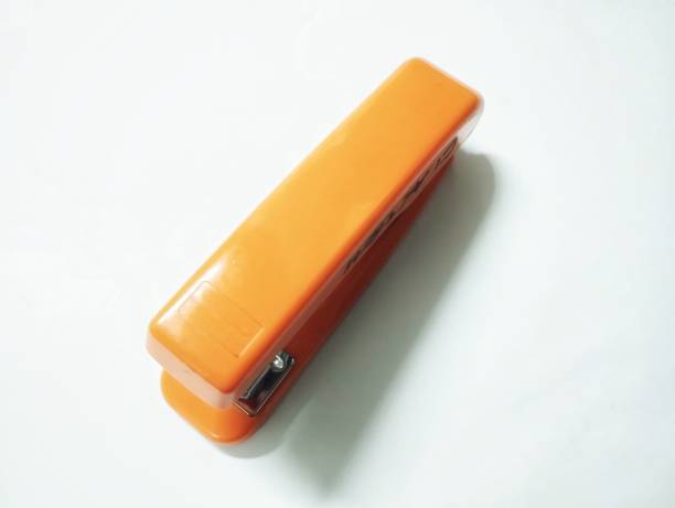 The minimalist composition emphasizes the stapler as the focal point.