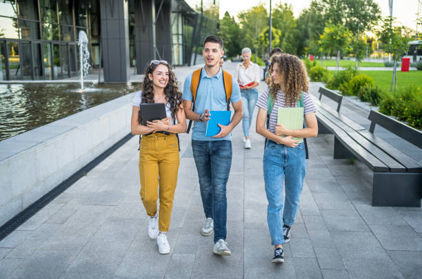 istock Friends walking on university campus 2164819890