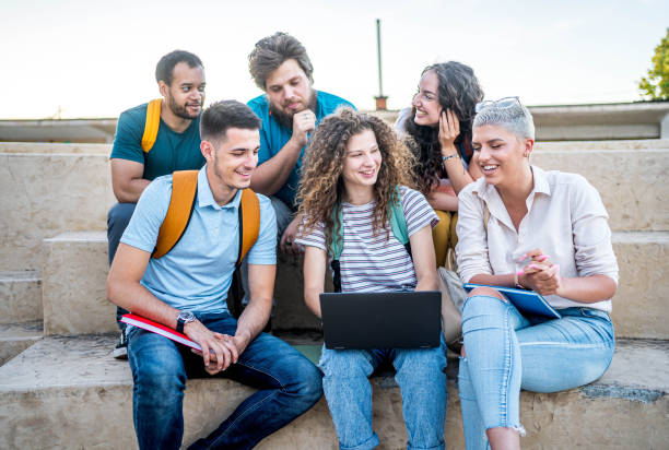 istock Group of students gathers around a laptop 2164819965
