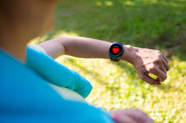 istock Woman looking at her smart watch for a pulse trace 2164823827