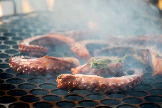istock octopus tentacles grilling on hot coals with smoke 2164824054