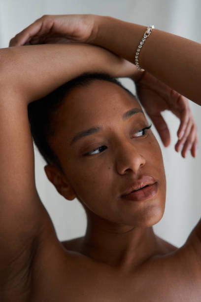 istock Young black woman posing with arms raised 2164825026