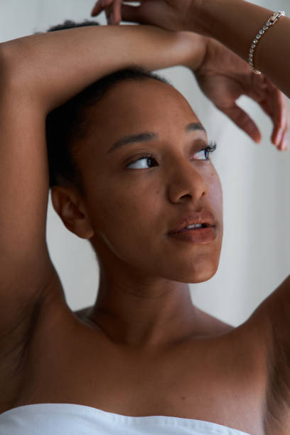 istock Young woman posing with hands on head and looking up 2164825048