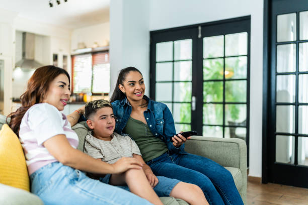 istock Family watching tv at home 2164825130