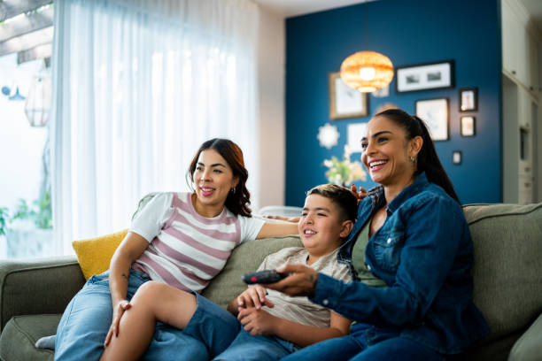 Family watching tv at home