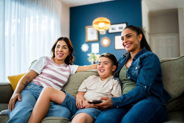 istock Family watching tv at home 2164825142