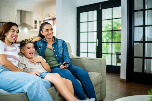 istock Family watching tv at home 2164825145