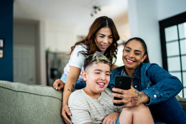 istock Mothers and son using mobile phone at home 2164825155