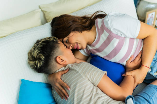 istock Mother and son lying down on bed at home 2164825255