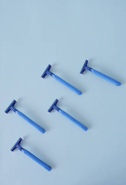 istock Composition of blue disposal plastic razors in a light blue background 2164825439