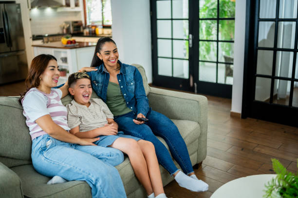 istock Family watching tv at home 2164825709