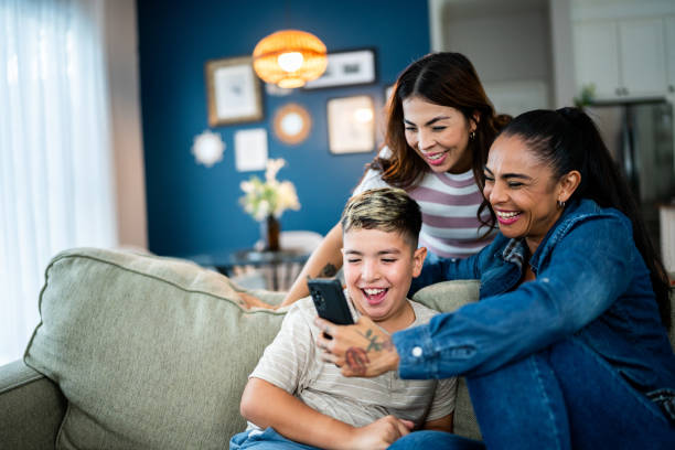 istock Mothers and son using mobile phone at home 2164826248