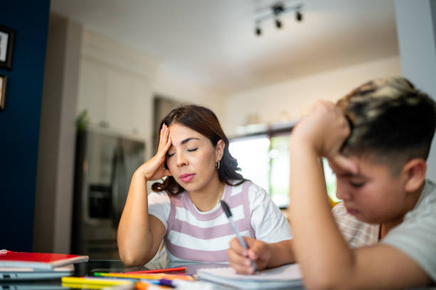istock Displeased mother and son doing homework at home 2164826282