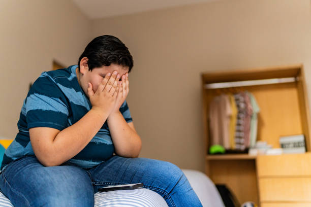 istock Sad child boy in bedroom at home 2164826414