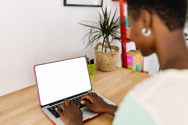 istock Mockup image of young african woman using laptop computer with blank screen 2164826555