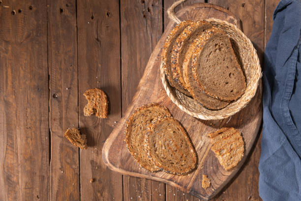 Whole Grain rye bread with seeds on a wooden board. Top view