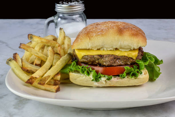 istock cheese burger  on a brioche bun served with fries 2164828207