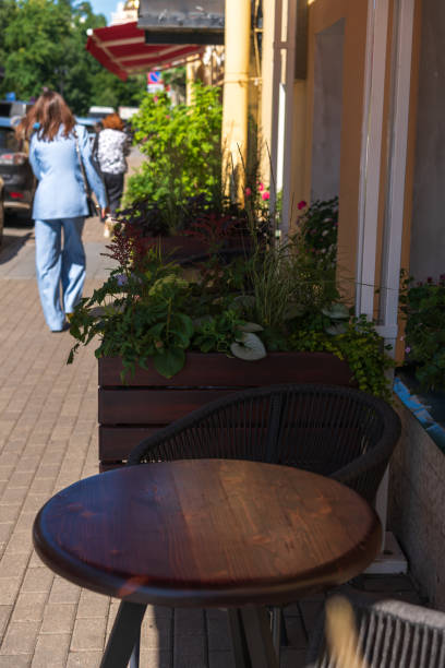 istock Empty wooden table in sidewalk cafe 2164830474