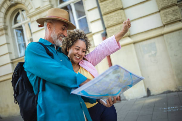 istock Elderly married couple exploring new city with map. 2164832743