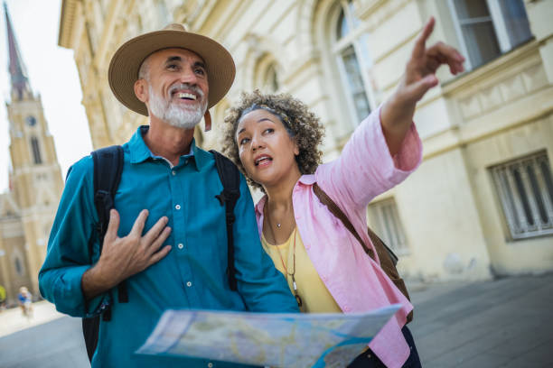 istock Elderly married couple exploring new city with map. 2164832749
