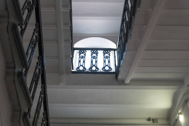 Low angle view of stair landing in old fashioned residential building. Light from windows. Soft focus. Copy space. Architecture features theme.