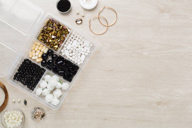 istock Tools and beads for making handmade jewelry on wooden background, top view 2164833731