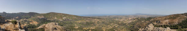 Sweeping view from Casteddu Etzu castle, capturing Sardinia's rolling hills and coastal horizon.