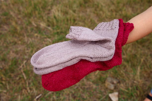 istock A person's hand holding a red and white sock 2164837481