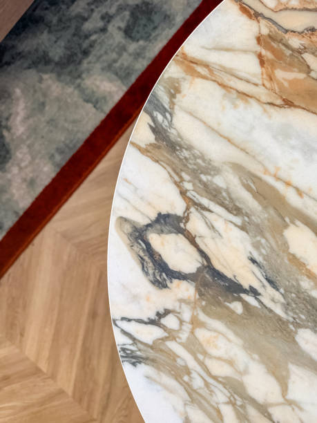 part of round marble table with grey carpet on background