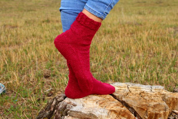 istock A person wearing red boots and red socks standing on a log 2164837605