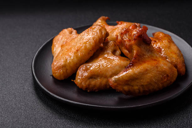 istock Delicious fried chicken wings with salt, spices and herbs 2164841129