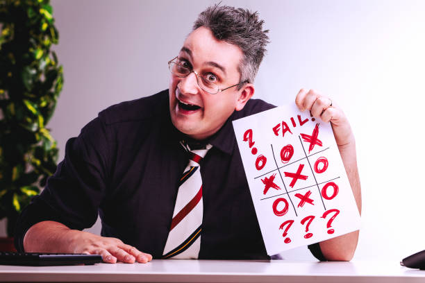 istock Businessman holding tic tac toe game showing fail result 2164844134