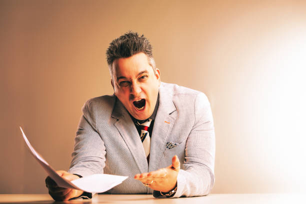 istock Enraged businessman yelling at documents in office meltdown 2164844965