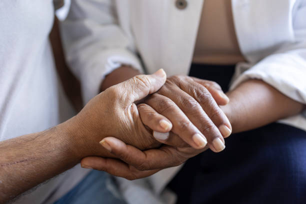 istock Health professionals holding hands with patients 2164846399