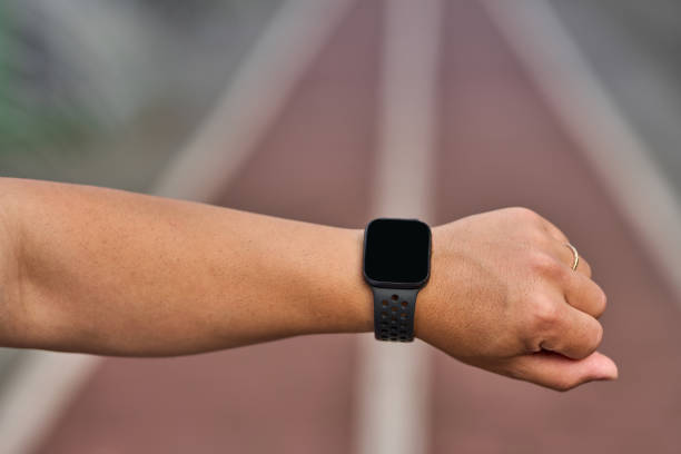 young man with smart watch on his wrist on jogging path.