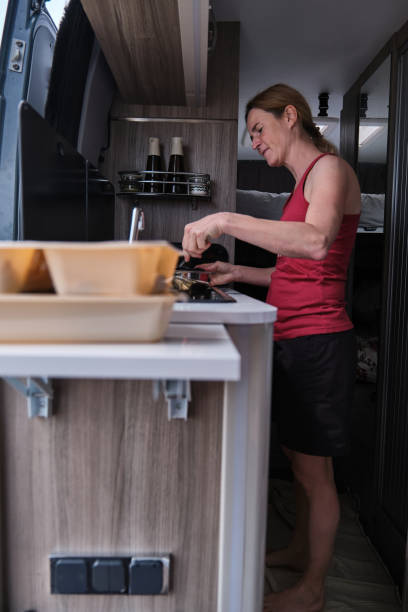 istock A Woman cooking in a camper van during her summer vacation 2164846964