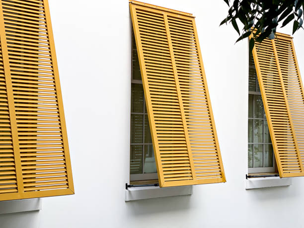 istock Yellow Shutters Against a White Building at the Beach 2164848487