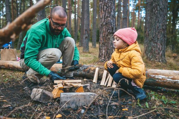istock A father and his young daughter work together to build a campfire 2164849080