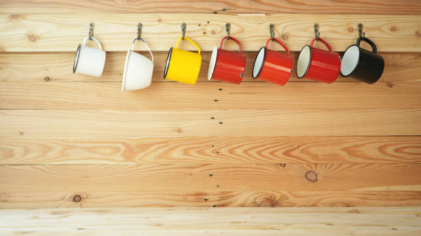 cups hanging on a wooden wall