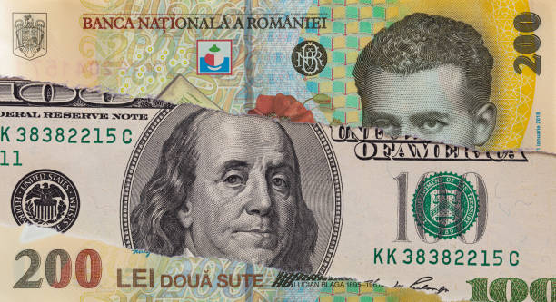 istock 100 dollar banknote through torn 200 Romanian Lei banknote 2164851714