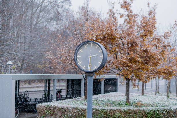 istock Modern architecture. Clock at the station on a snowy day. 2164852267
