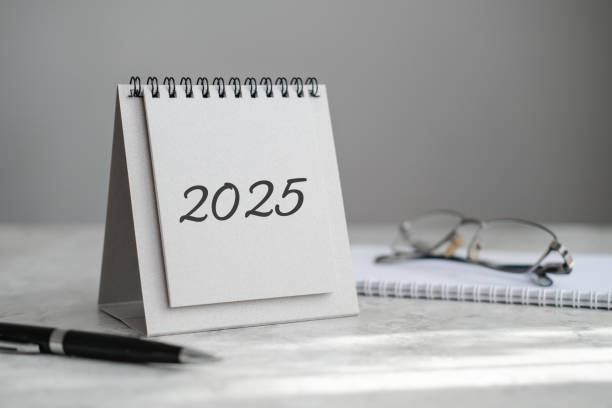 istock Desk calendar 2025, notebook, glasses and pen on the table 2164852514