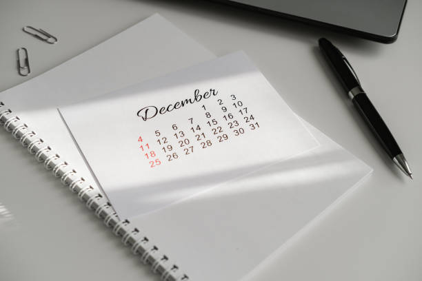 istock Office workspace with December calendar, notepad and laptop 2164852533