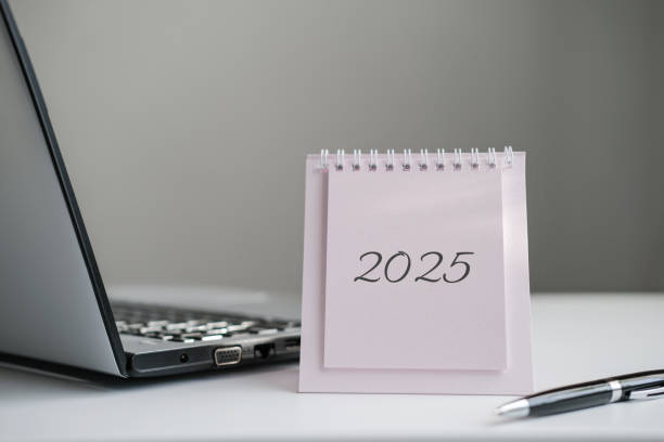 istock Calendar 2025 and laptop on office desk 2164852554