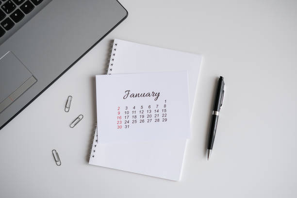 istock January calendar, notepad and laptop on the office table 2164852559
