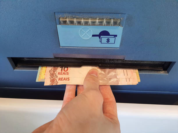 istock Withdrawing money from ATM 2164854939