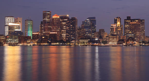 istock Boston skyline and harbor illuminated at night reflected on the Atlantic Ocean 2164856694