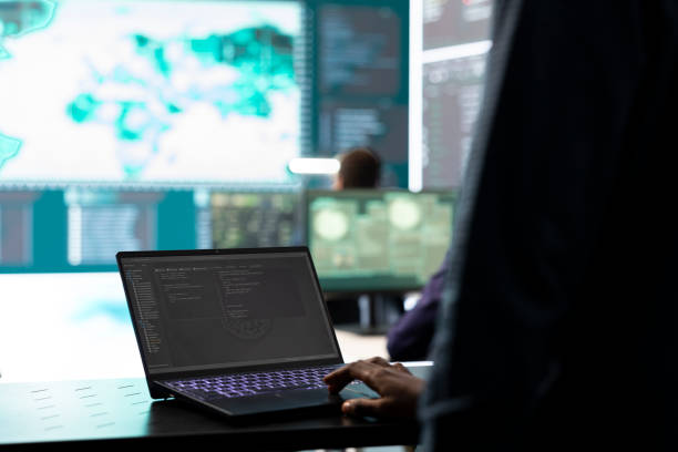 istock Governmental IT expert examines cyber threats on big screen and laptop 2164859422